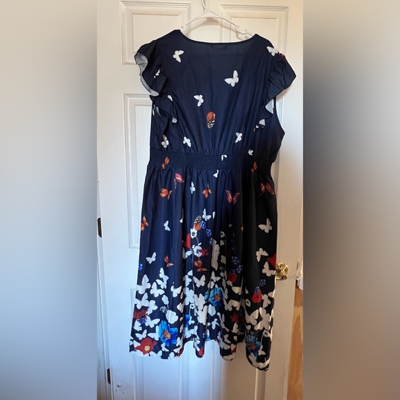 BloomChic ruffled sleeveless navy dress covered in butterflies. Below the knee. - Picture 3 of 7
